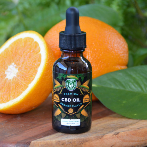 A bottle of 450mg CBD oil with orange flavor.