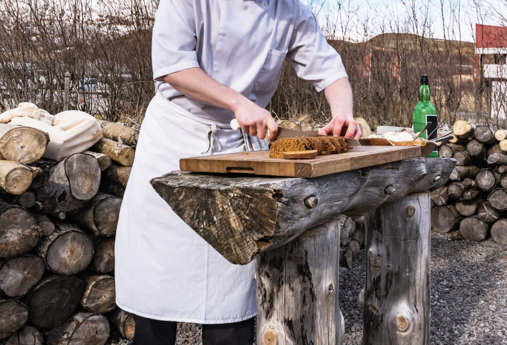 A chef cutting Icelandic bread.