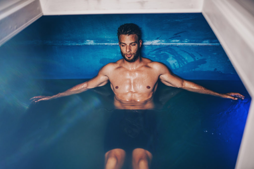 A man floating in a sensory deprivation tank. 