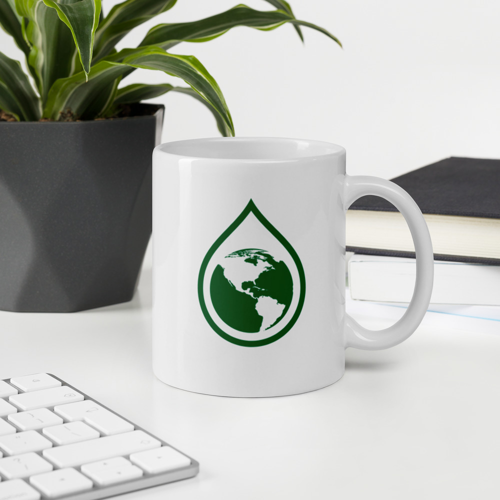A white mug with Life Grows Green earth drop on side.